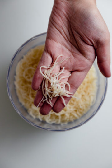 kunafa dough shredded and placed on palm to show 2.5 cm in length.