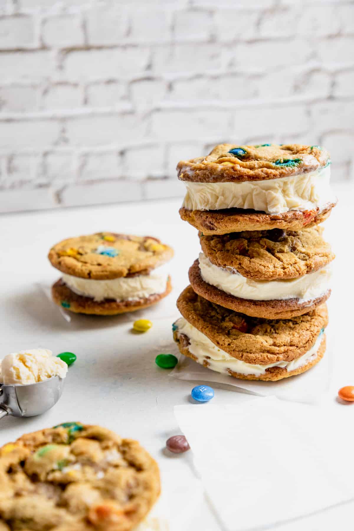 M&M ice cream cookie sandwiches stacked on top of each other. 