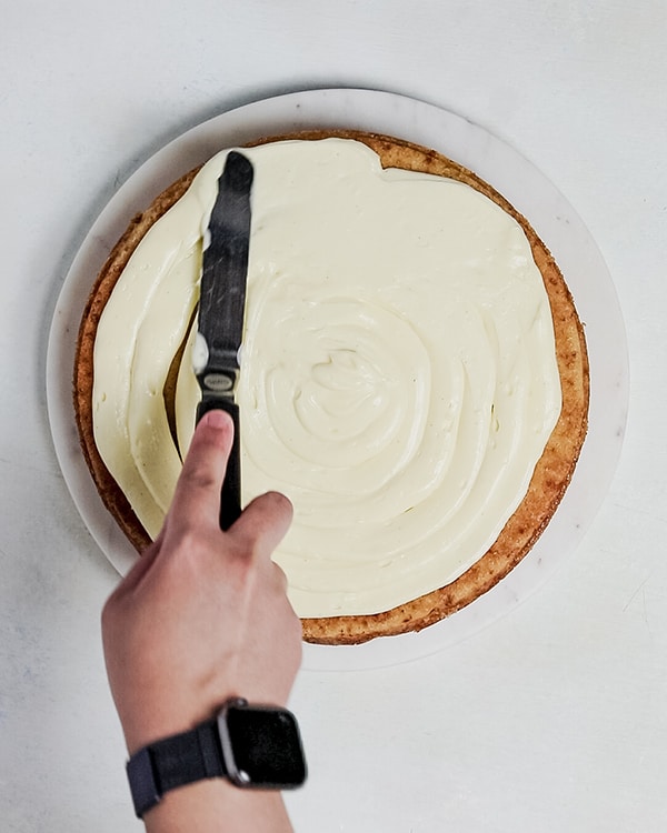 apply cream cheese to the first vanilla cake layer