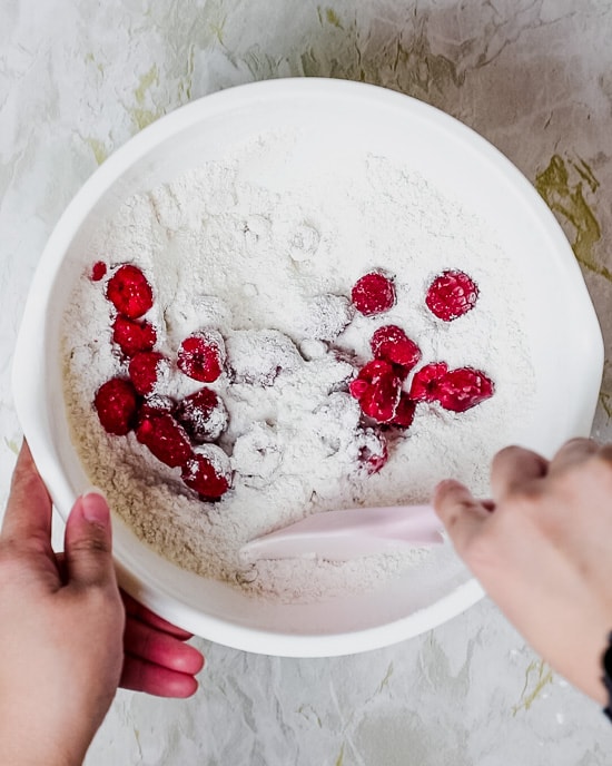 mixing the dry ingredients and fresh raspberries