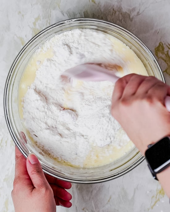 mixing the wet ingredients with the dry ingredients using a spatula