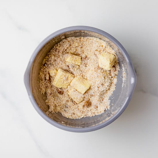 sugar, flour, butter, and cinnamon in a grey bowl.