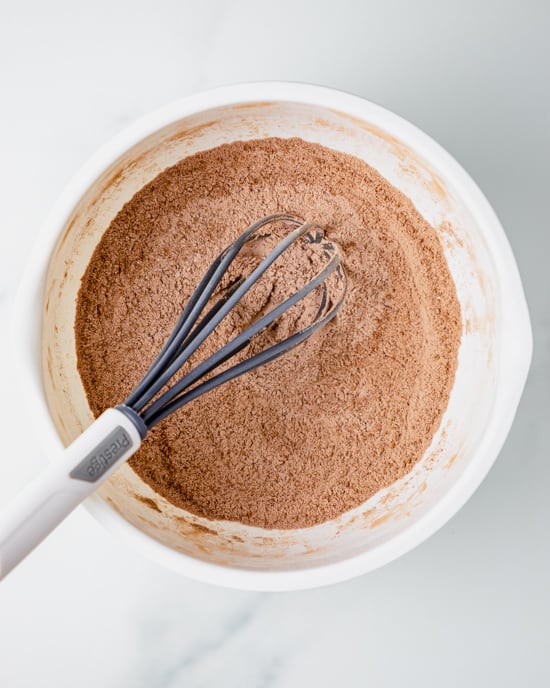dry ingredients in a white bowl with a whisk