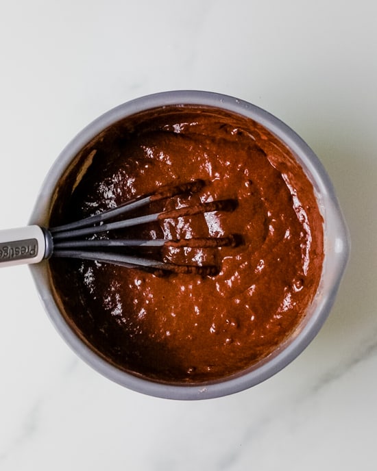 chocolate pancake batter in a grey bowl with a whisk