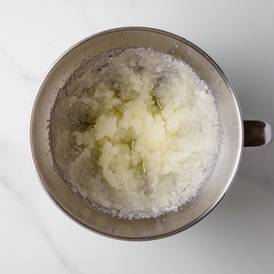 vegetable oil and sugar fluffed in a stainless steel bowl. 