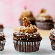 gluten free german chocolate cupcake on a white marble top.