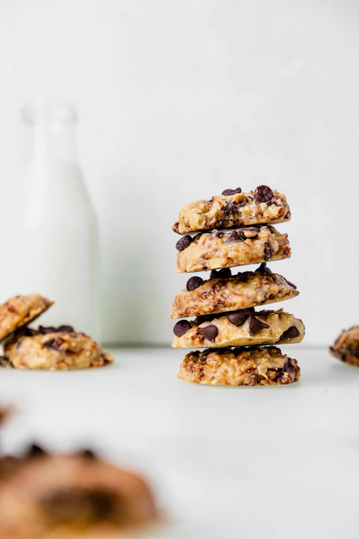 No bake oatmeal cookies with chocolate chips stacked on top of each other.